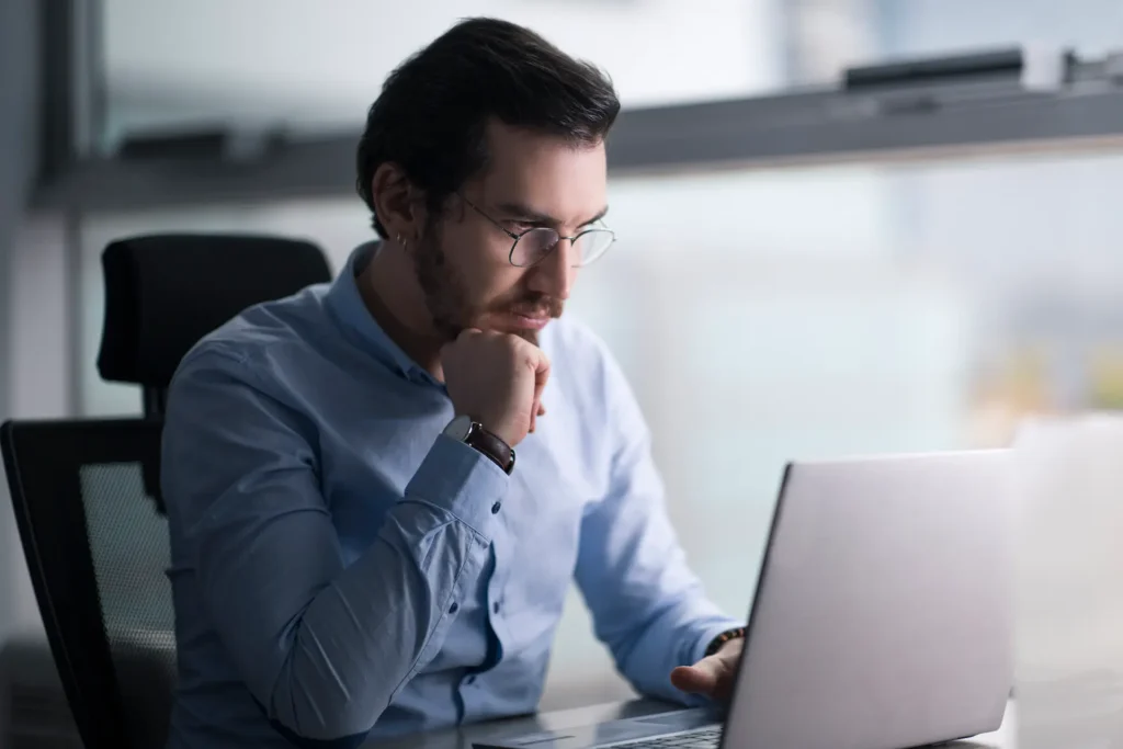 Man searching for a suit online on his laptop