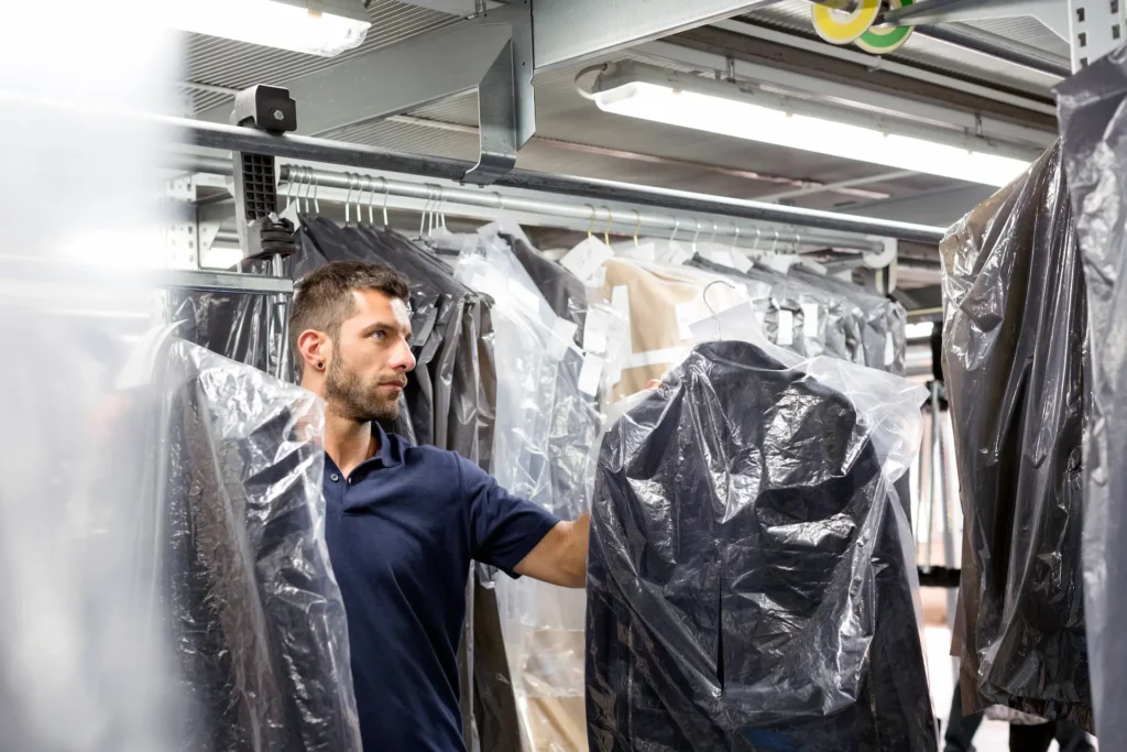 Male warehouse worker doing garment stock take in 2023 11 27 05 12 56 utc